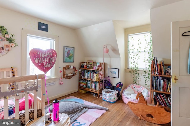 bedroom featuring vaulted ceiling and wood finished floors