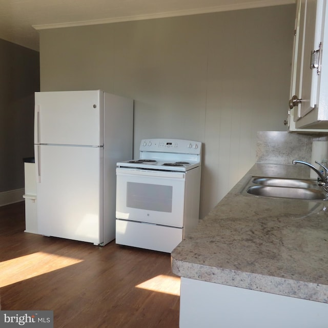 kitchen with white appliances, white cabinetry, light countertops, and a sink