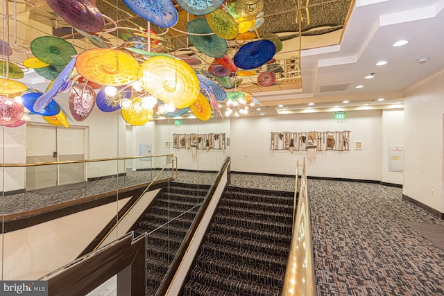 interior space featuring a tray ceiling, recessed lighting, carpet, and baseboards