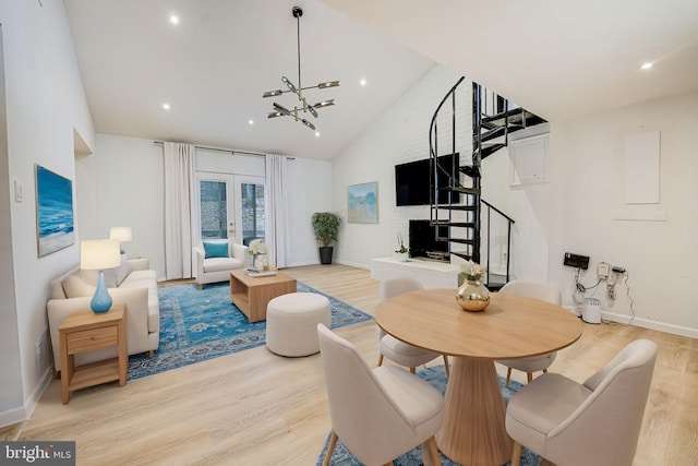 living room featuring light wood-style floors, stairway, and french doors