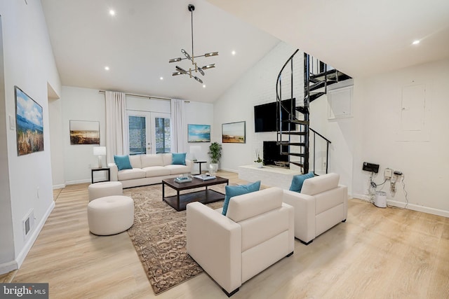 living area with visible vents, stairs, french doors, light wood-type flooring, and high vaulted ceiling