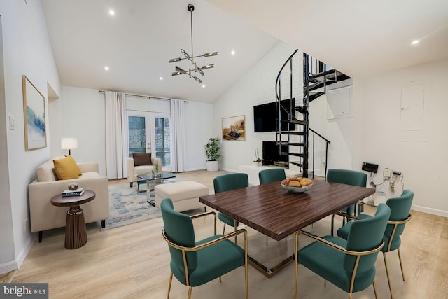 dining room with baseboards, light wood-style flooring, an inviting chandelier, stairs, and french doors