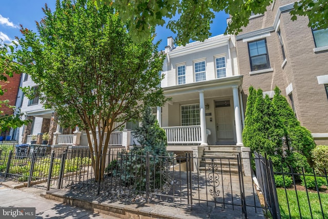 view of front facade featuring a fenced front yard and covered porch