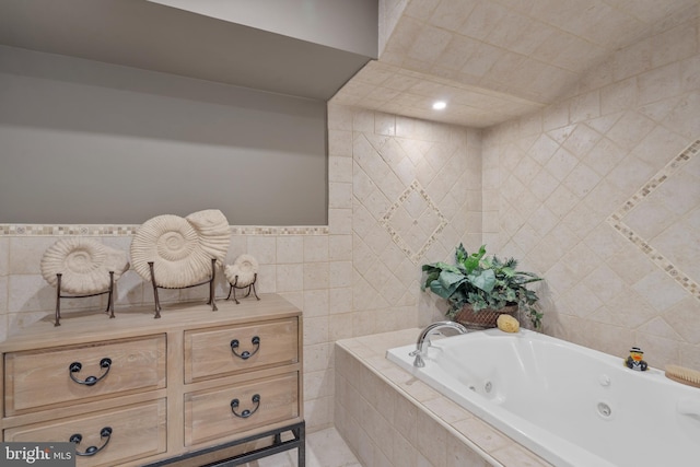 full bathroom featuring tile walls and a jetted tub