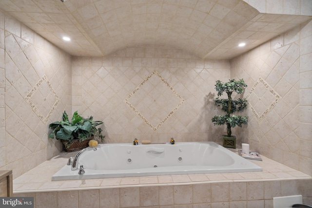 full bathroom featuring recessed lighting, tile walls, and a whirlpool tub