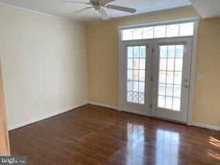 interior space with ornamental molding, dark wood finished floors, and baseboards