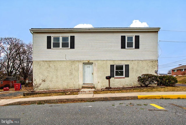 view of front of house featuring entry steps and stucco siding