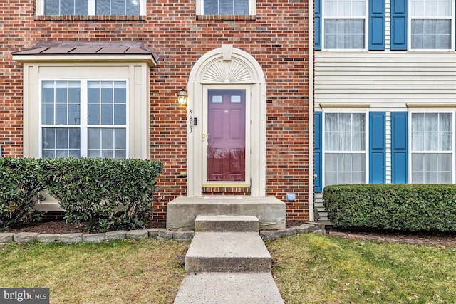 entrance to property with brick siding