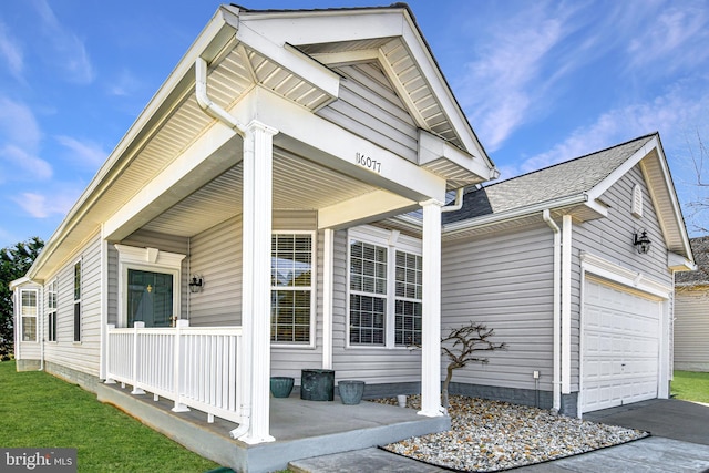 exterior space featuring a garage, a shingled roof, a porch, and concrete driveway