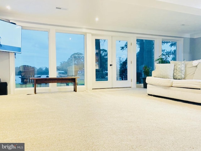 living room featuring visible vents and carpet flooring