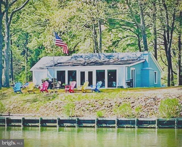 back of house with a water view