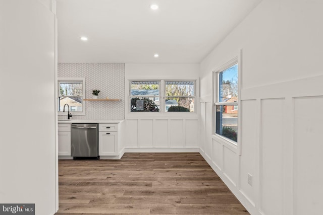 kitchen featuring open shelves, light countertops, white cabinets, wood finished floors, and dishwasher