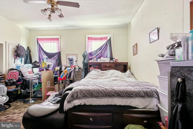 bedroom featuring ceiling fan and multiple windows