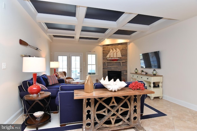 tiled living room featuring baseboards, coffered ceiling, beam ceiling, and a stone fireplace