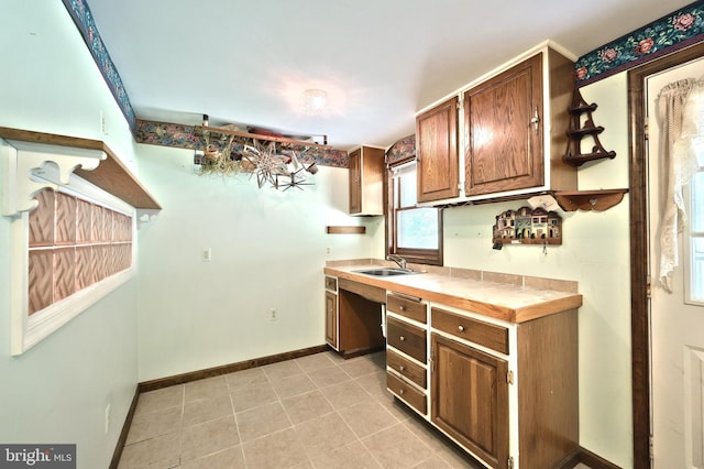 60 Fernwood Ln, Fairfield, PA 17320 - kitchen with a sink, tile countertops, baseboards, light tile patterned floors, and brown cabinetry