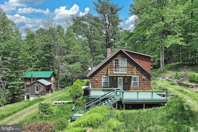 60 Fernwood Ln, Fairfield, PA 17320 - view of front facade with a balcony, a deck, a chimney, and a forest view