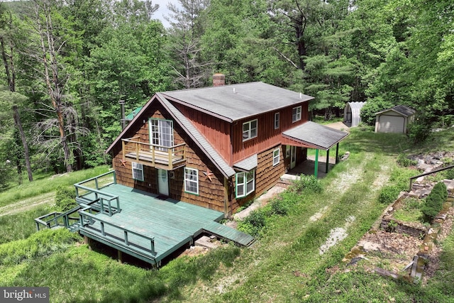 60 Fernwood Ln, Fairfield, PA 17320 - back of property featuring a chimney, roof with shingles, a wooded view, and an outbuilding