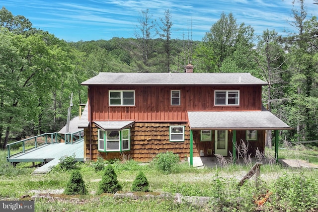 60 Fernwood Ln, Fairfield, PA 17320 - rustic home with a forest view, covered porch, a chimney, and roof with shingles