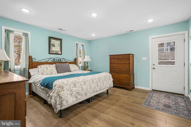 bedroom featuring recessed lighting, visible vents, baseboards, and wood finished floors