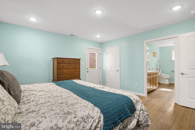 bedroom featuring recessed lighting, visible vents, baseboards, and wood finished floors