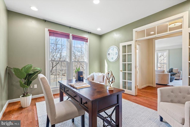 office with baseboards, wood finished floors, and a healthy amount of sunlight