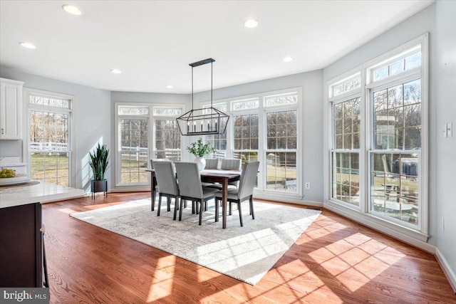 dining area featuring baseboards, light wood-style flooring, and recessed lighting