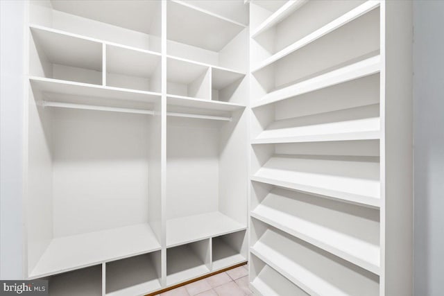 spacious closet with tile patterned floors