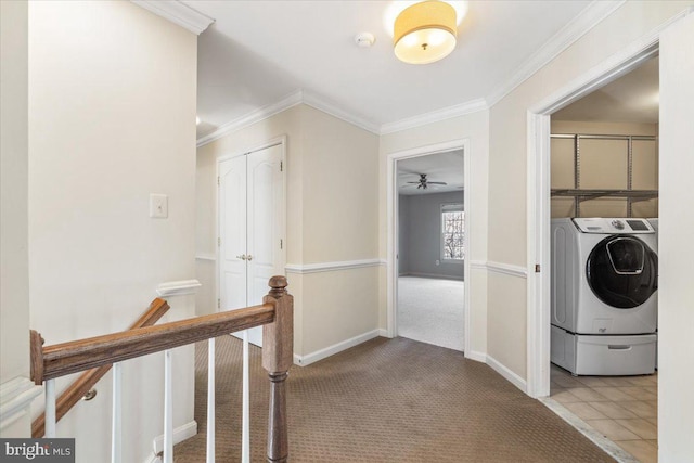 interior space featuring crown molding, washing machine and dryer, carpet flooring, an upstairs landing, and baseboards