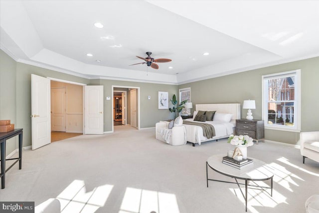 bedroom featuring recessed lighting, a raised ceiling, light carpet, and baseboards