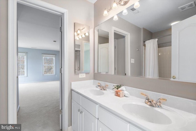 bathroom featuring double vanity, curtained shower, a sink, and visible vents