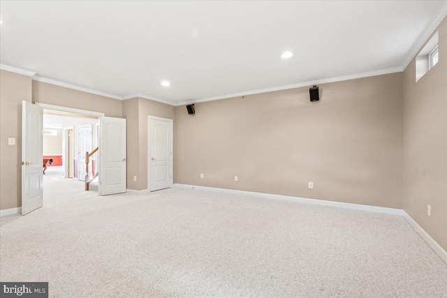 empty room featuring recessed lighting, baseboards, crown molding, and light colored carpet