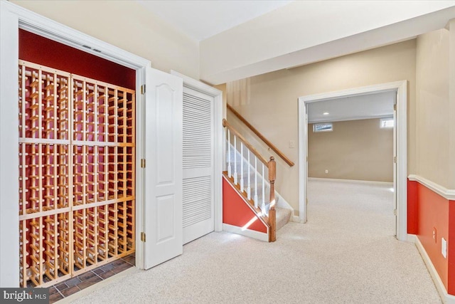 wine room featuring carpet and baseboards