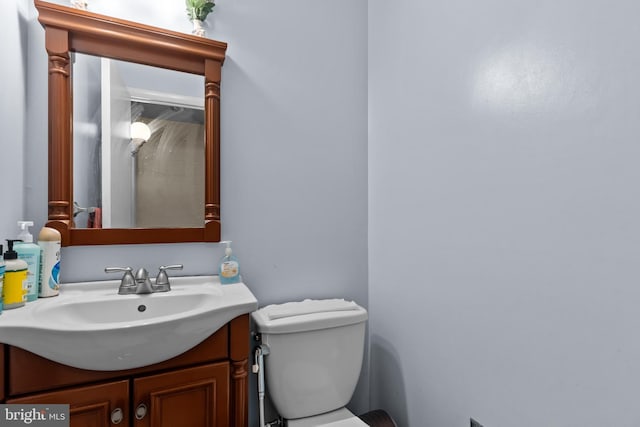 bathroom featuring toilet and vanity