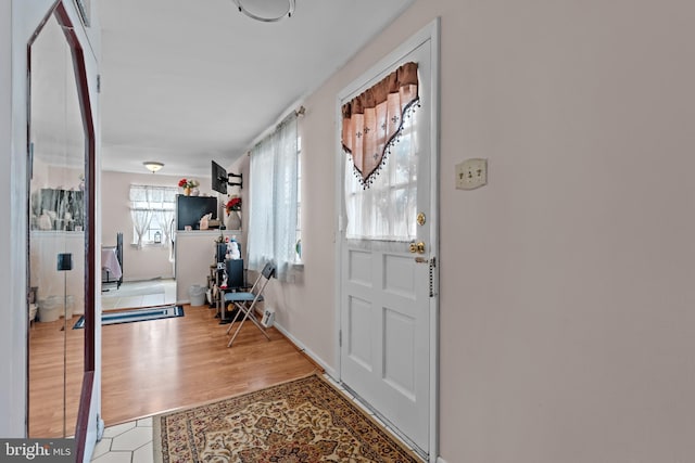 doorway with light wood finished floors