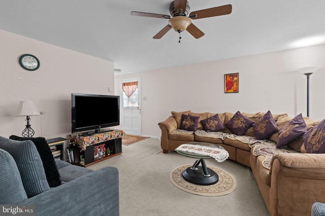 living room featuring carpet and a ceiling fan