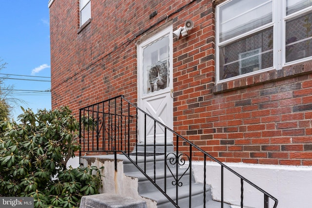 property entrance featuring brick siding