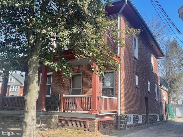 view of front of property with brick siding and a porch