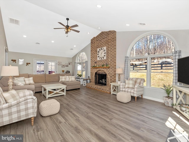 living area with a wealth of natural light, wood finished floors, and visible vents