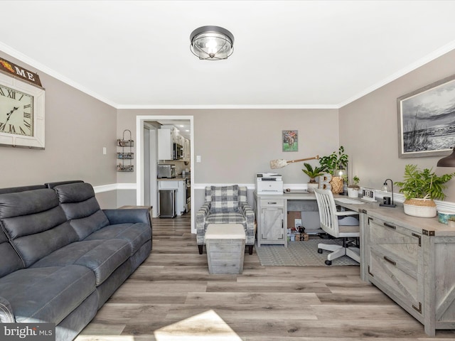 office area featuring ornamental molding and light wood-style flooring