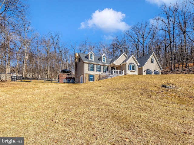 back of house with a lawn and fence