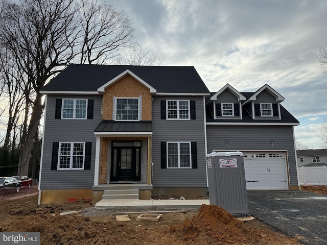 colonial house featuring a garage and driveway