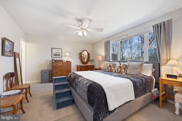 bedroom with baseboards, a ceiling fan, and light colored carpet