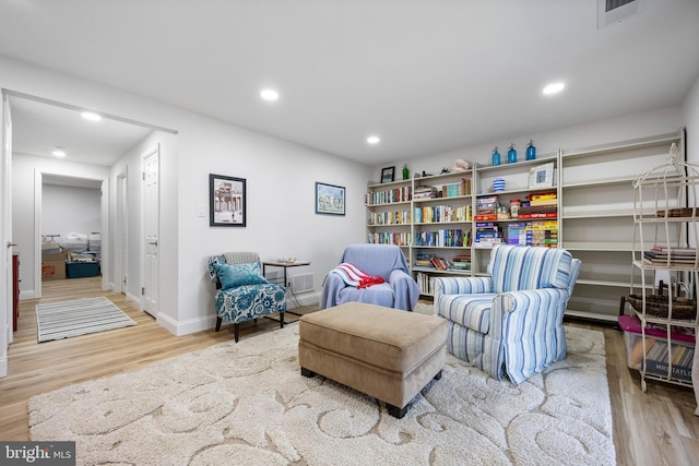 sitting room with recessed lighting, visible vents, baseboards, and wood finished floors