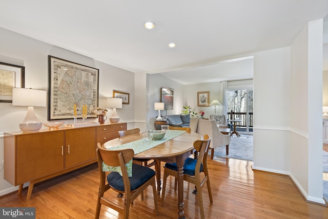 dining area with light wood-style floors, baseboards, and recessed lighting