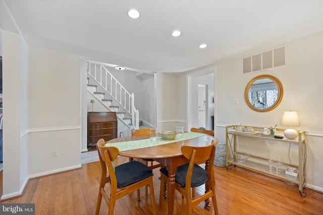 dining area with recessed lighting, visible vents, baseboards, light wood-style floors, and stairway