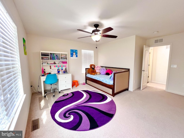 bedroom with baseboards, visible vents, and a ceiling fan