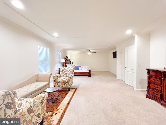 bedroom featuring ornamental molding, light colored carpet, ceiling fan, and baseboards