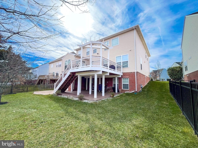 rear view of house with brick siding, a yard, a patio, stairway, and a fenced backyard