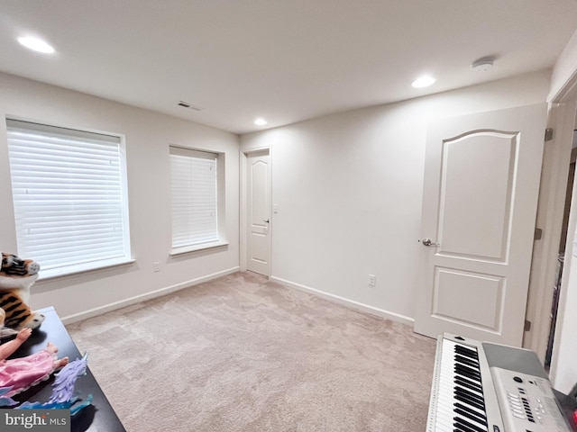 unfurnished room featuring baseboards, recessed lighting, visible vents, and light colored carpet