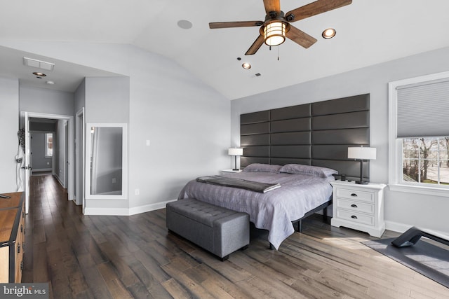 bedroom with lofted ceiling, wood finished floors, and baseboards